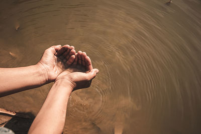 Midsection of person in lake