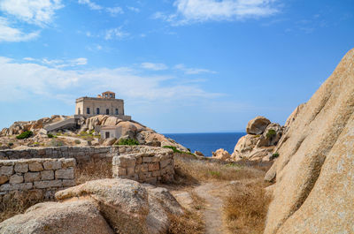 Castle by sea against sky