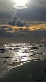 Scenic view of beach against sky during sunset