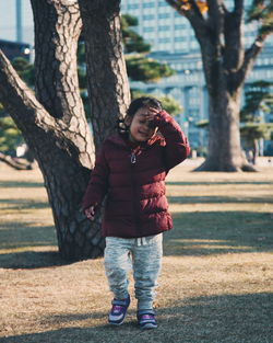 Girl in warm clothing walking at park