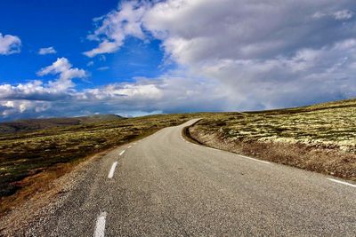 Road amidst landscape against sky