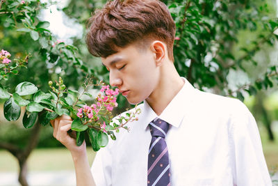 Portrait of young man against plants