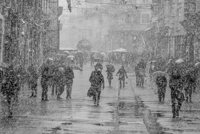 People walking on street during rainy season