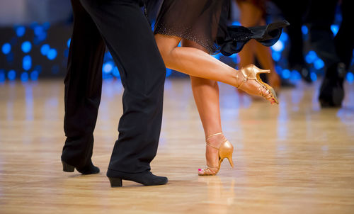 Low section of couple dancing on floor