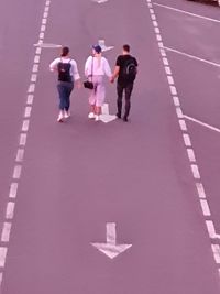 High angle view of people walking on road