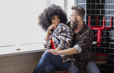 Young couple sitting outdoors