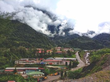 Scenic view of trees and buildings against sky