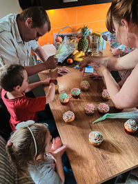 High angle view of people sitting on table