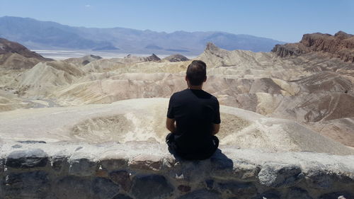 Rear view of man looking at mountains