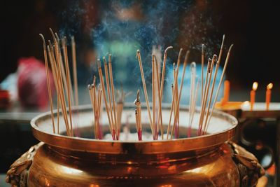 Close-up of burning candles in temple