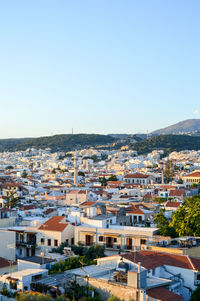 High angle view of houses in town against clear sky