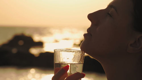 Close-up of woman holding wineglass