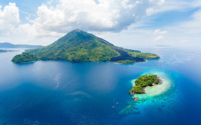 Scenic view of sea and island against sky