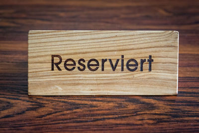 Close-up of reserve sign on table