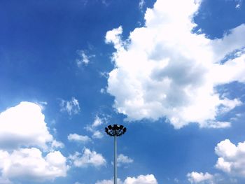 Low angle view of floodlight against blue sky