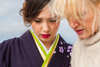 Close-up portrait of young woman in kimono dress