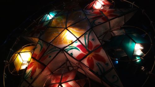 Low angle view of illuminated lighting equipment at home