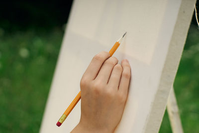 Close-up of hand holding cigarette