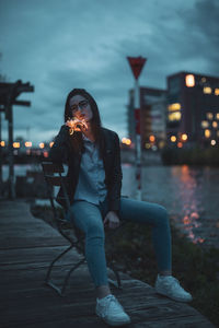 Young woman sitting outdoors