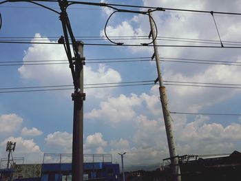 Low angle view of electricity pylon against sky