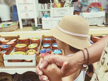 Midsection of woman holding hands at market stall