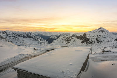 Scenic view of snowcapped mountains against sky during sunset