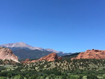 Scenic view of mountains against clear blue sky