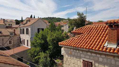 Houses in town against sky