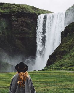 Scenic view of waterfall against sky