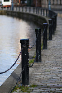 Wooden post on footpath by river