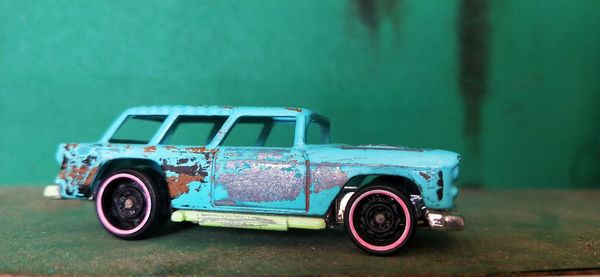 Toy car against blue wall