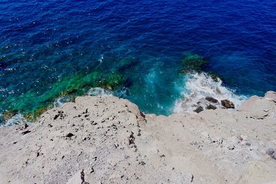 High angle view of rock by sea