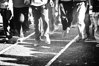 Low section of people walking on road