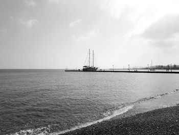 Sailboats on sea against sky