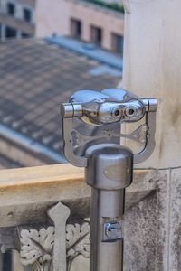 Close-up of pipe on railing against building