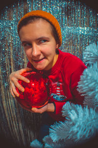 Portrait of mature man holding christmas decoration