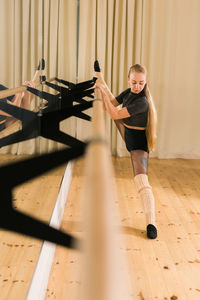 Side view of young woman exercising in gym