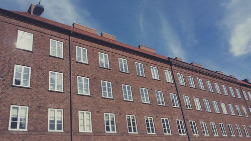 Low angle view of building against cloudy sky