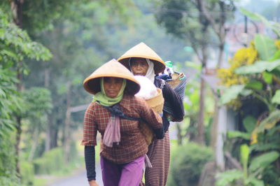 Female vendors carrying baskets on road