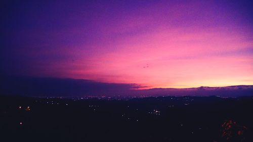 Scenic view of mountains against sky at dusk