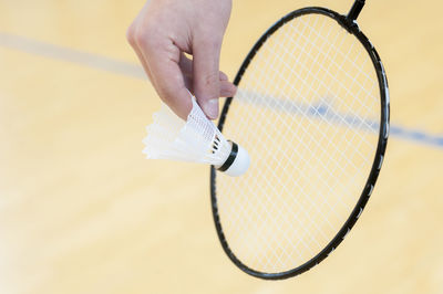 Cropped hand playing badminton