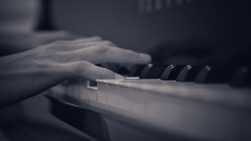 Close-up of hands playing piano