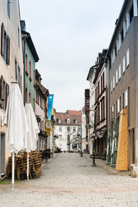 Street amidst buildings in town against sky