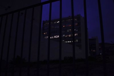 Illuminated cityscape against sky at night