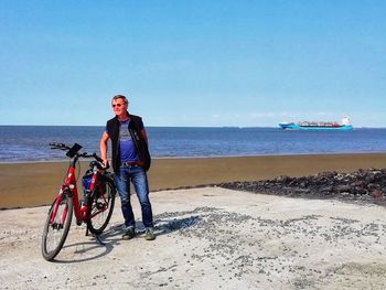 Man riding bicycle on beach