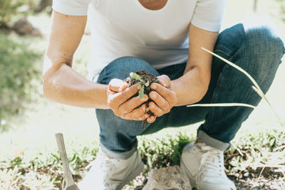 Low section of woman holding soil