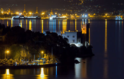 View of illuminated harbor at night