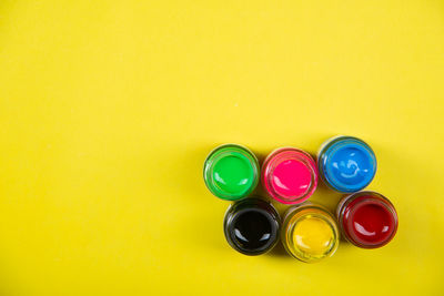 High angle view of multi colored pencils on yellow background