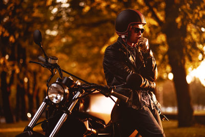 Man contemplating by motorcycle