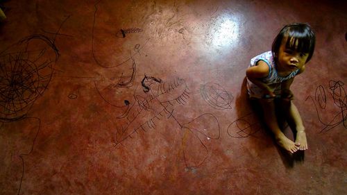 Portrait of girl sitting on floor